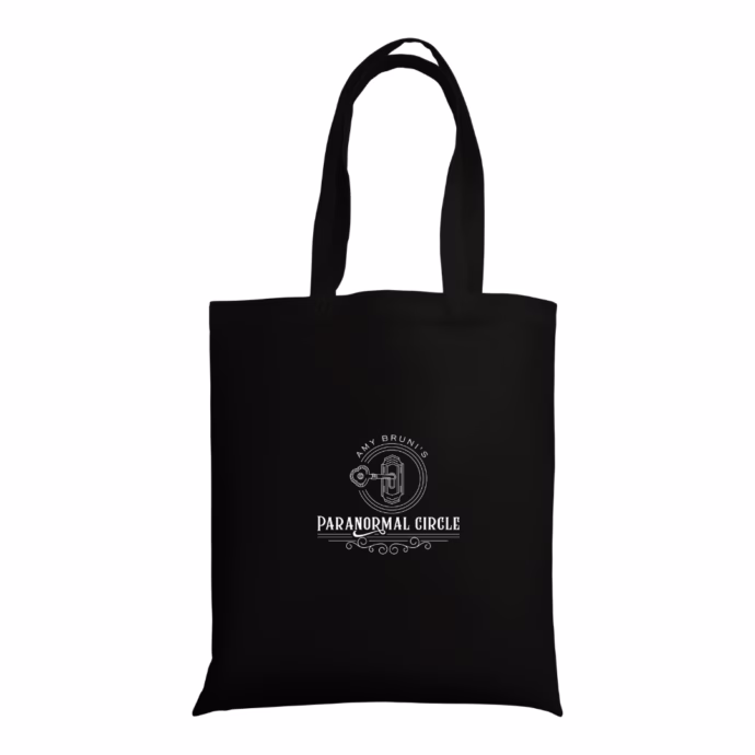 Black canvas tote bag with the Paranormal Circle logo printed on the front, ideal for carrying essentials.
