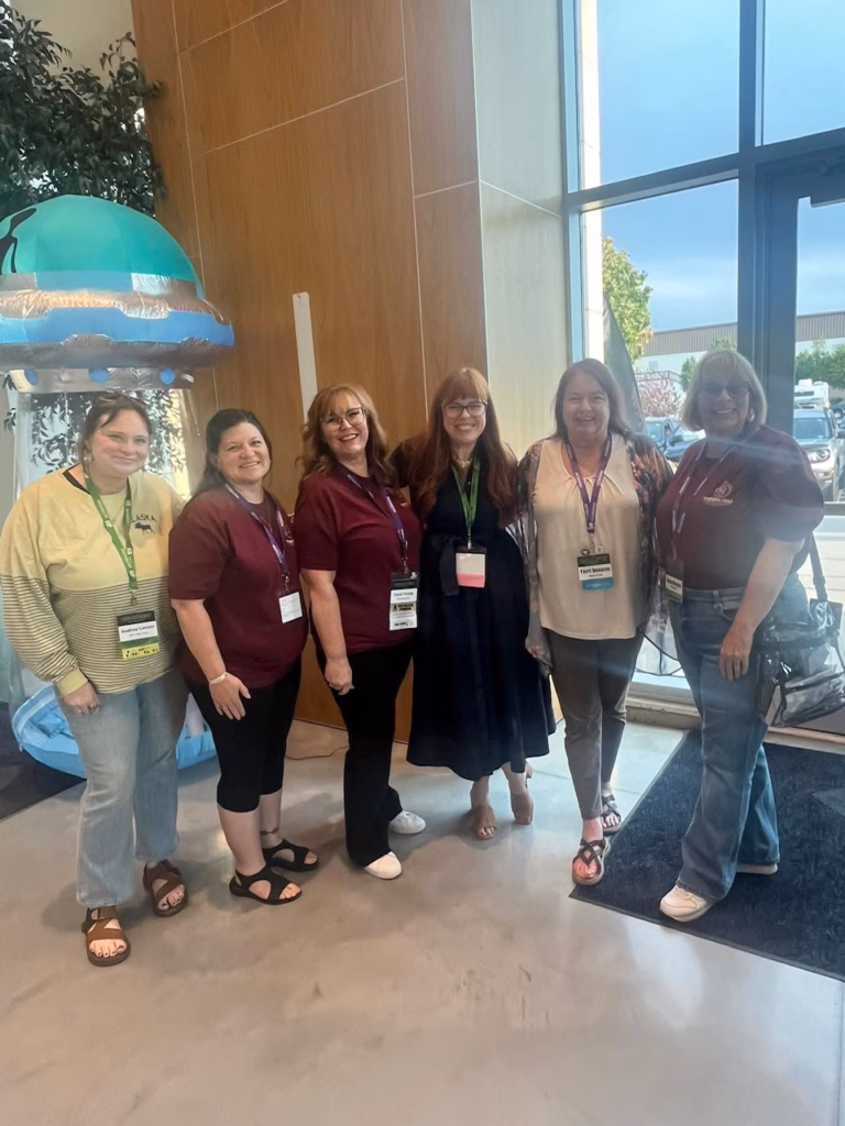 Amy Bruni stands with Paranormal Circle members at the entrance of the conference center.